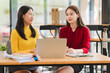 © Kritdanai - Two Young Women Collaborating at Desk