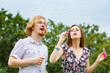 © Voyagerix - Couple blowing soap bubbles, having fun