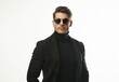 © PUTRI - Serious body guard or secret agent wearing suit and sunglasses, isolated on grey background