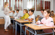 © JackF - Young boys and girls studying in classroom during lesson in school.