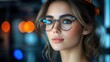 © JO BLA CO - A young woman wearing stylish glasses gazes thoughtfully while seated in a contemporary cafe. Soft lighting enhances her features, creating an inviting ambiance in the evening
