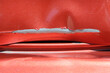 © esvetleishaya - Close up of a red car with multiple visible scratches and paint damage The scratches expose the underlying metal, creating a contrast against the glossy surface. Perfect for automotive damage concepts