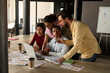 © Demetr White/Stocksy - Office manager explains task to group of workers