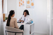 © Evgeniia Siiankovskaia/Stocksy - A woman at a consultation with a gynecologist in a private clinic.