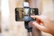 Hand starting shooting video blog in Bari street