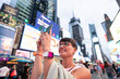 © Alvaro Lavin/Stocksy - Tourist taking pictures in Times Square, New York City