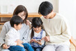 © TAGSTOCK2 - スマホを見る家族
