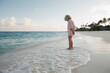 © Tanya Yatsenko/Stocksy - A girl standing on the beach in Maldives
