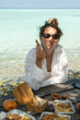 © Alina Hvostikova/Stocksy - Enjoying a delicious meal by the beach at sunset