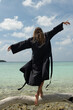 © Alina Hvostikova/Stocksy - Dancing joyfully by the tranquil lagoon on a sunny day