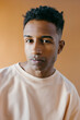 © Jimena Roquero/Stocksy - Studio portrait of young handsome man with serious expression