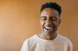 © Jimena Roquero/Stocksy - Studio portrait of young handsome man laughing
