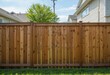 © Kitta Studio - Wooden Fence with Green Tree and Clear Sky in Residential Area