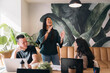 © Santi Nuñez/Stocksy - Coworkers laughing together during a business meeting