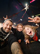 © Alvaro Lavin/Stocksy - Father and daughters taking selfie making funny faces