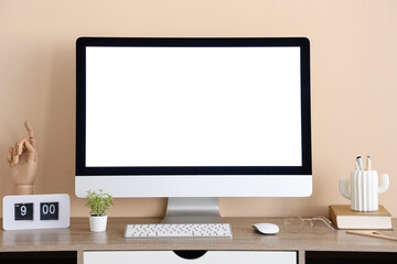Wall Mural - stylish workplace with modern computer, clock and stationery near beige wall in office