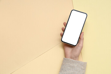 Wall Mural - woman holding mobile phone on color background
