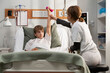 © Danil Nevsky/Stocksy - Young patient lifting dumbbell with physiotherapist