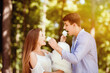 © Prostock-studio - Romantic date. Young guy and girl feeding cotton candy to each other at park
