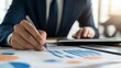 © KerXing - Business Professional Analyzing Financial Reports with Pen in Hand