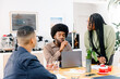© Adrian Rodd/Stocksy - A confident Black woman leads a team discussion during a meeting