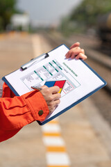 Wall Mural - action of an engineer is checking on the chemical hazard material form with background of crude oil 
