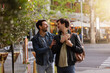 © VICTOR TORRES/Stocksy - Romantic stroll of a gay couple in lively Madrid streets
