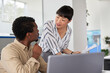 © Jovo Jovanovic/Stocksy - Woman explaining colleague over his laptop
