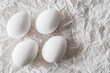 © Anna - White eggs placed on crumpled paper, creating a minimalist and organic composition. Soft natural light enhances textures, making it ideal for Easter, food photography, and rustic backgrounds