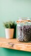 © Aleksandra - A draft with copy space of a glass jar with dried lavender and herbs.