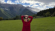 © Alina Hvostikova/Stocksy - Woman enjoys serene day in Georgian mountains under cloudy sky