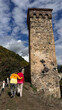 © Alina Hvostikova/Stocksy - Couple walking near a historic tower in Svaneti, Georgia