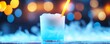 © Wimon - Frosty blue coconut and vanilla rum cocktail, beautifully contrasted with a bright yellow flame, glowing under a wintry ice-blue bokeh effect.