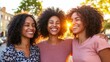 © Anuphong - Three Happy Women Friends Smiling at Sunset in City Street