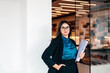 © Lucas Ottone/Stocksy - Professional executive businesswoman looking at camera