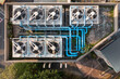 © Lawren Lu/Stocksy - Aerial View of Rooftop Cooling System with Fans and Pipes