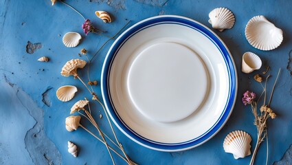 Poster - White ceramic plate with blue rim centered on a blue background, surrounded by seashells and dried flowers in warm tones.