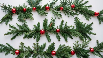 Poster - Festive flat lay of conifer tree branch garlands with red baubles on a clean white background, arranged symmetrically with ample copy space.