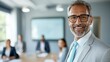 © Worldwide - Confident businessman in formal attire smiles warmly during a corporate meeting in modern office