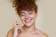 © mahalo studio/Stocksy - Beautiful woman applying perfume with closed eyes and smiling