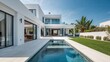 © Levan - Modern white villa with spacious backyard and swimming pool under a clear blue sky, featuring ample copyspace for text or design insertion.