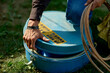 © Connect Images - A person handles a blue container labeled 'Ropes' outdoors on grass. Brandenburg, Germany