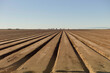 © Connect Images - Wide view of freshly plowed agricultural field under clear blue sky on a sunny day. California, USA
