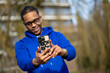 © Connect Images - Man in blue hoodie taking a selfie outdoors with a personalized phone case. Arnhem, Netherlands
