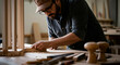 © DP - Skilled artisan shaping wood in a sunlit workshop captures the essence of craftsmanship and dedication