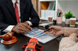 © kamiphotos - a lawyer is explaining the details of a car insurance policy to the car owner before she signs it, a lawyer explains to his client what will happen if she doesn't get car insurance
