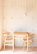 © Lawren Lu/Stocksy - Minimalist Dining Area with Wooden Table and Concrete Wall