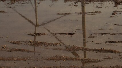 Leinwandbilder - Reflection of wind turbine in water with sky