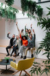 © VICTOR TORRES/Stocksy - Diverse group of professionals celebrating success together