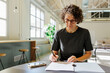 © BONNINSTUDIO/Stocksy - Formal businesswoman signing contract in bright office space